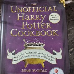 the official harry potter cookbook is on display in a store window, and it's purple cover