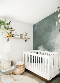 a baby's room with a white crib in the corner