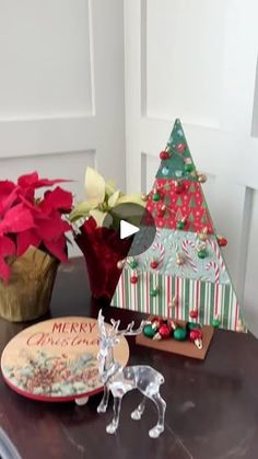 a wooden table topped with christmas decorations and flowers