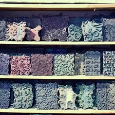 several different types of decorative tiles on shelves