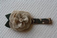 a flower on a headband is laying on the ground next to some fabric material