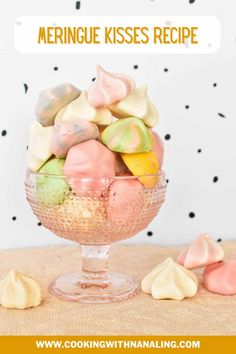 a glass bowl filled with colorful meringue kisses