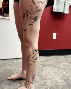 a woman's legs with tattoos on them