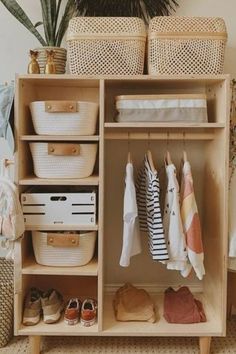 an organized closet with baskets and clothes