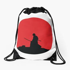 a drawsack bag with the silhouette of two people holding swords in front of a red sun