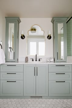 a bathroom with double sinks and two mirrors