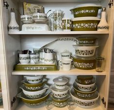 the shelves are filled with dishes and containers