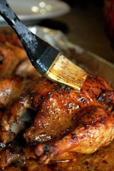 a spatula being used to brush off the top of a chicken