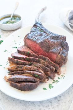 a white plate topped with sliced up steak