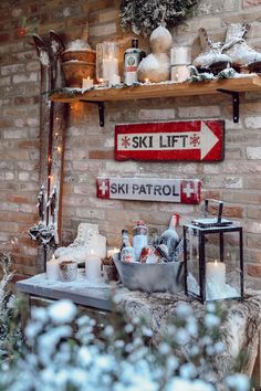 a brick wall with shelves filled with bottles and candles next to a sign that says ski lift