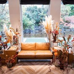 a living room filled with lots of furniture and flowers