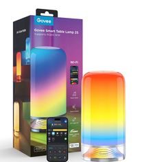 the colorful speaker is next to its box