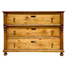 a wooden dresser with three drawers on it