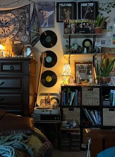 a room filled with lots of records and pictures on the wall