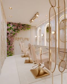 there are several chairs in the room with flowers on the wall behind them, along with mirrors and lights