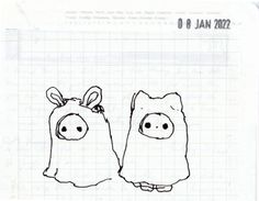 a drawing of two piggy heads on top of a piece of paper with writing underneath it