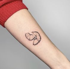 a woman's arm with a black and white butterfly tattoo on the left forearm