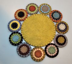 a circular piece of art made out of different colored circles