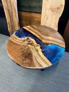 a wooden chair with blue glass in the seat and wood back rest on carpeted floor