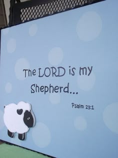 a blue sign that says the lord is my shepherd with a sheep magnet on it