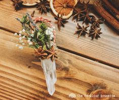 an arrangement of oranges and star anise on a wooden table