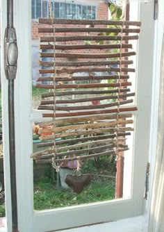 an open door with a window covered in wooden slats