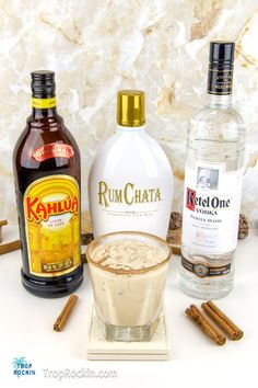 the ingredients to make rumchata are displayed on a white surface with cinnamon sticks