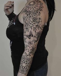 a woman with a black and white tattoo on her arm