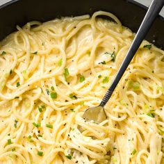 a skillet filled with pasta and topped with parsley