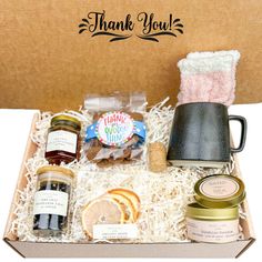 an open box containing jams, cookies and condiments with thank you written on it