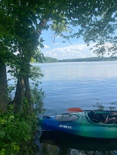 a kayak sitting on the shore of a lake