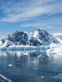 the mountains are covered in snow and ice as well as some water on the ocean