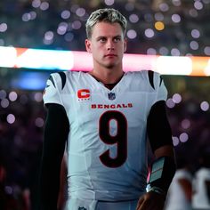 a man in a football uniform standing on the field