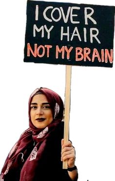 a woman holding a sign that says i love my hair not my brain