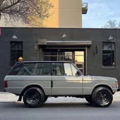 an suv parked in front of a building