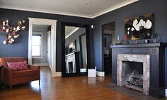 a living room with blue walls and wood floors