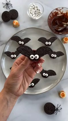 a plate with cookies decorated to look like bats and googly eyes for halloween decorations