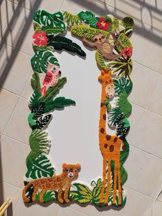 the letter l is made up of felt animals and plants