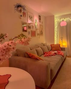 a living room filled with lots of furniture and flowers on the table in front of it