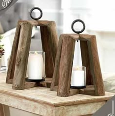 two wooden candle holders sitting on top of a table