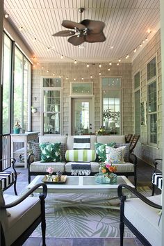 a living room filled with furniture and lots of windows