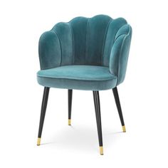 a blue velvet chair with black legs and gold trimmings on the armrest