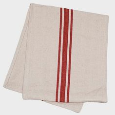 two red and white towels folded on top of each other, one with a stripe