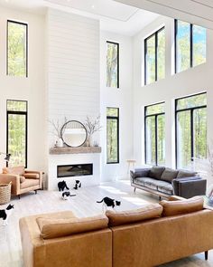 a large living room with high ceilings and lots of windows