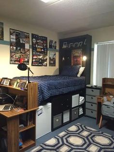 a dorm room with a bed, desk and computer