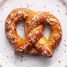 two pretzels on a plate with sesame seeds