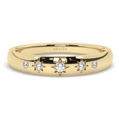 a yellow gold ring with three diamonds