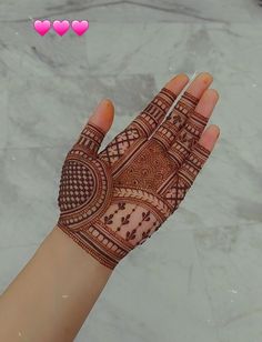 a person's hand with henna on it and the words love written in arabic