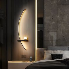 a bedroom with a bed, night stand and lights on the wall next to it