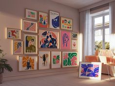 a living room filled with lots of framed art on the wall next to a window